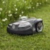 robotic lawnmower cutting grass near a wildflower area