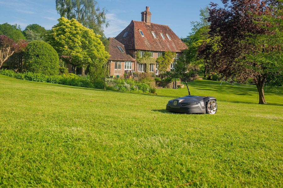 robot mower on grass outside house