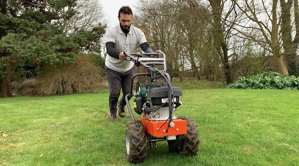 Professional robot mower installation using a cable laying machine to bury the wire